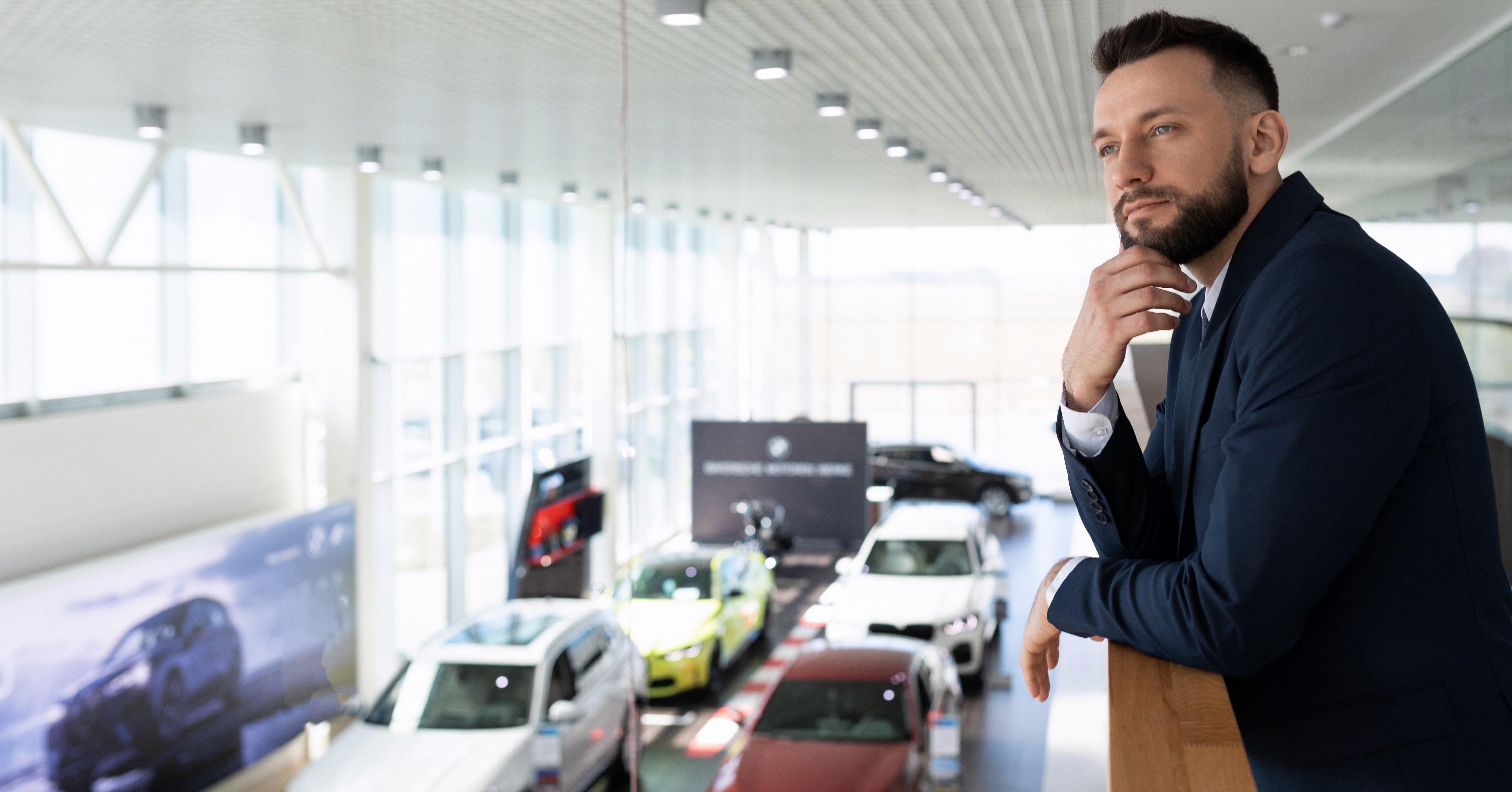 car-salesman-looking-at-lot-inventory-of-vehicles