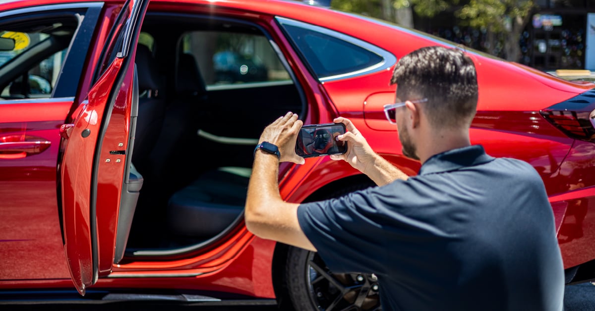 Image of a professional auto photographer shooting dealership vehicles