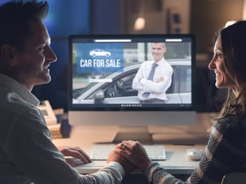 middle-aged couple looking online for a car