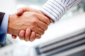 Business handshake after buying a new car