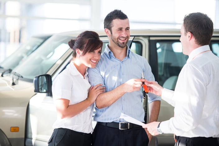Happy couple getting car keys from a car seller-1