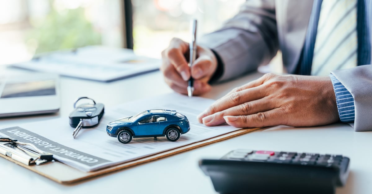 Car dealership manager calculating the ROI of hiring professional photographers