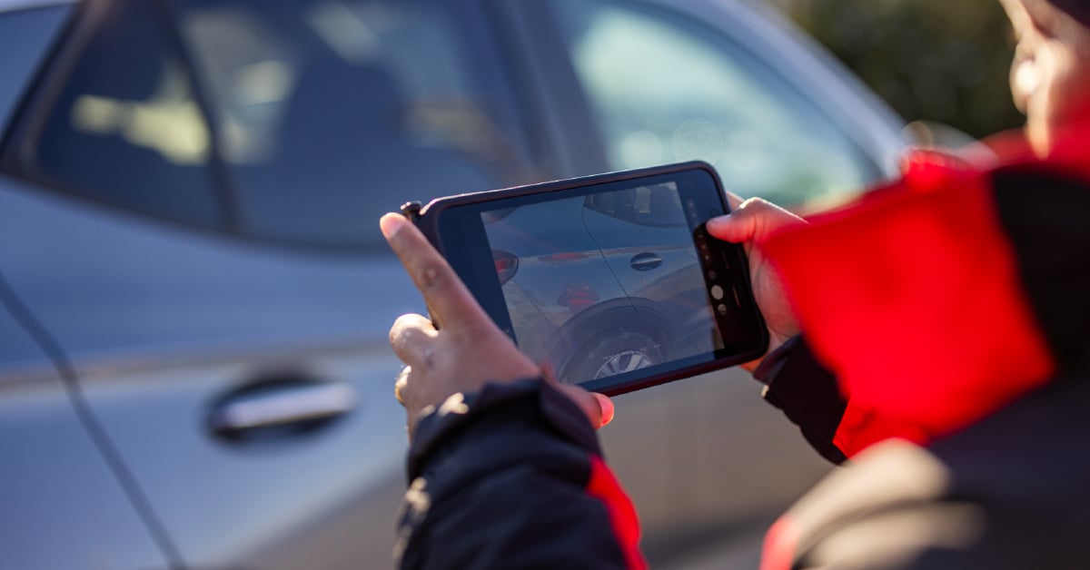 Professional car photographer taking pictures of a car door